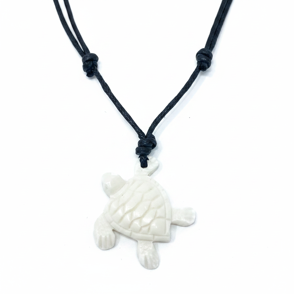 White carved bone sea turtle pendant close-up on white background